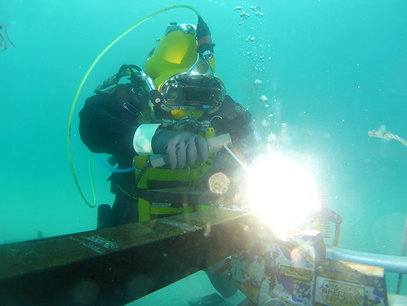 diving student welding underwater