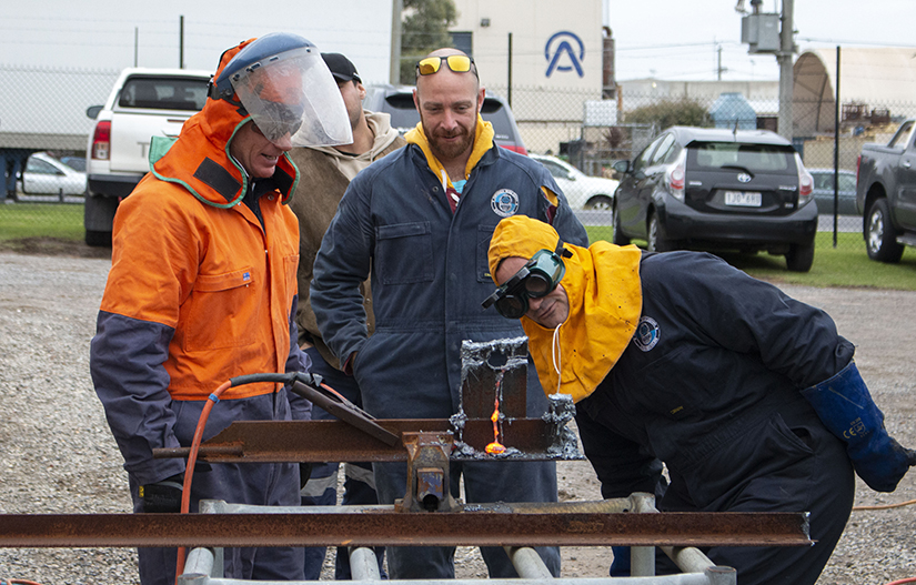 PDTA Trainer and students inspecting cutting tasks