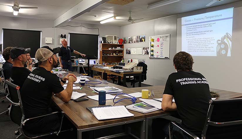 Dive supervisor course trainer and students studying gasses and temperature