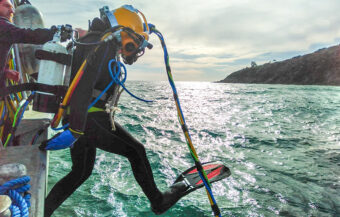 Commercial diving student entering water from boat